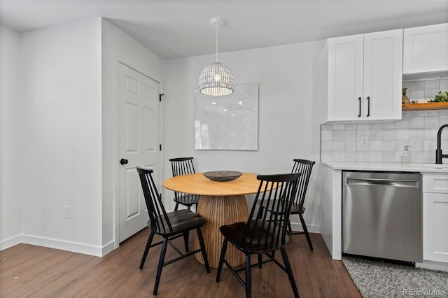 dining room featuring sink and dark wood-type flooring