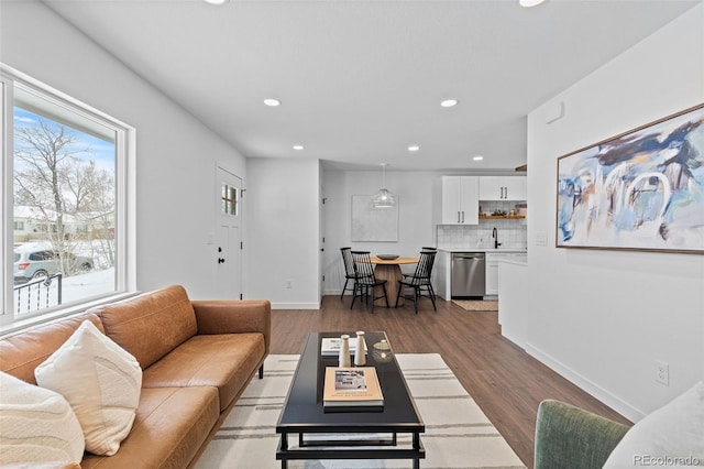 living room with dark hardwood / wood-style flooring and sink