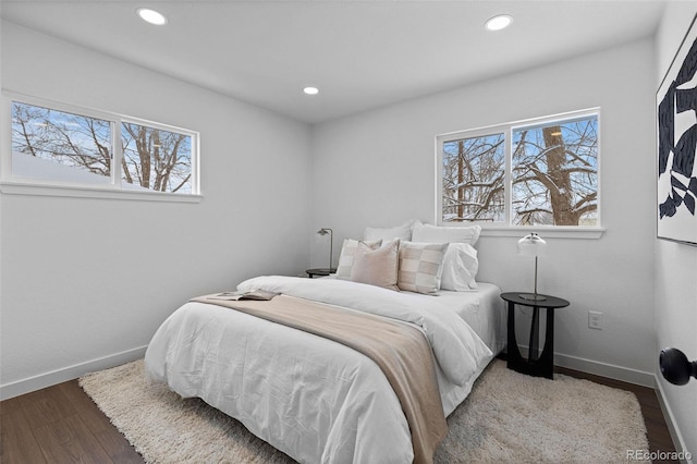 bedroom featuring multiple windows and hardwood / wood-style floors