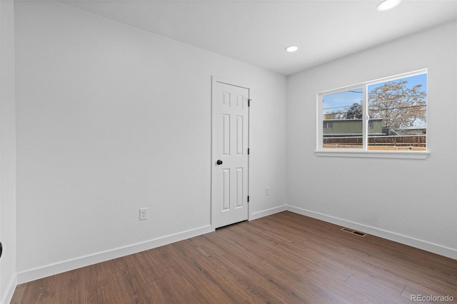 spare room with hardwood / wood-style floors