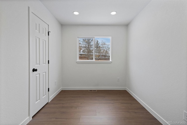 spare room featuring dark hardwood / wood-style flooring