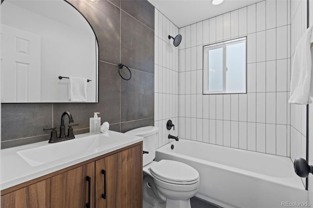 full bathroom with vanity, toilet, tiled shower / bath, and tasteful backsplash