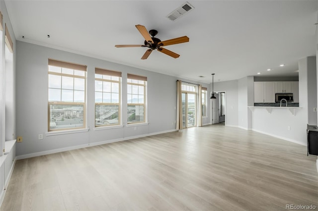 13456 Via Varra Unit 401, Broomfield, CO 80020 - unfurnished living room with light wood-style floors, ceiling fan, and recessed lighting