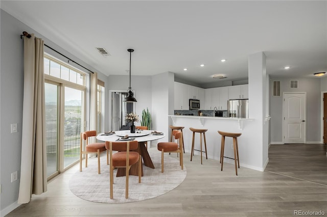 13456 Via Varra Unit 401, Broomfield, CO 80020 - dining room with light wood-style flooring and recessed lighting