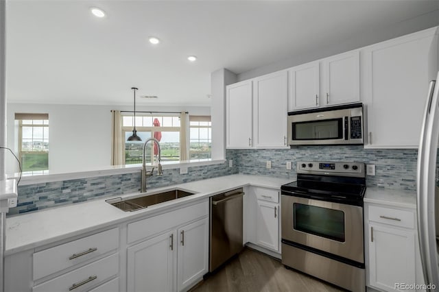 13456 Via Varra Unit 401, Broomfield, CO 80020 - kitchen featuring stainless steel appliances, healthy amount of natural light, white cabinetry, and recessed lighting