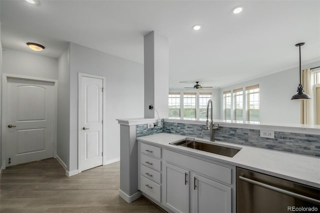 13456 Via Varra Unit 401, Broomfield, CO 80020 - kitchen with dishwasher, tasteful backsplash, recessed lighting, a ceiling fan, and wood finished floors