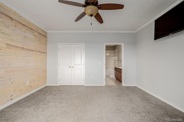 13456 Via Varra Unit 401, Broomfield, CO 80020 - unfurnished bedroom featuring carpet, ornamental molding, wooden walls, a closet, and ensuite bath