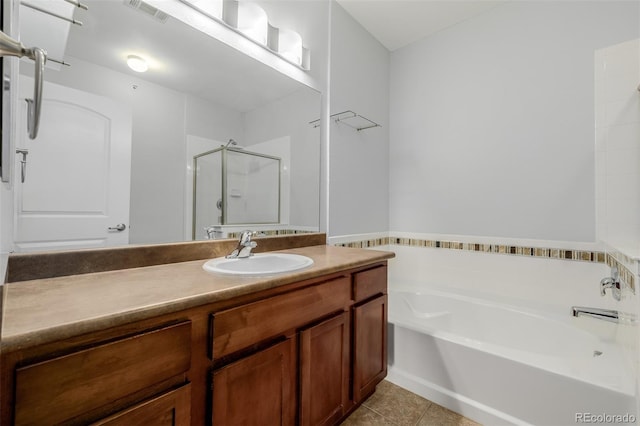 13456 Via Varra Unit 401, Broomfield, CO 80020 - bathroom featuring a garden tub, a stall shower, vanity, and tile patterned floors