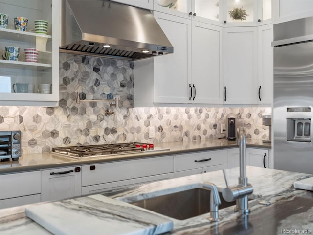 kitchen featuring extractor fan, white cabinetry, and tasteful backsplash