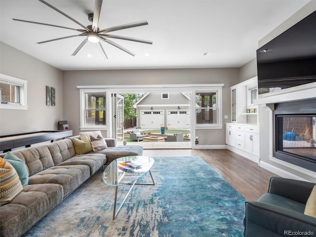 living room featuring ceiling fan and wood-type flooring