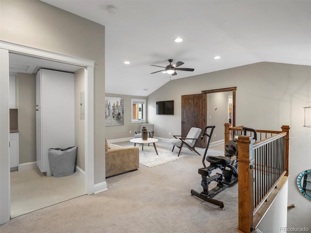 workout area with ceiling fan, light colored carpet, and lofted ceiling