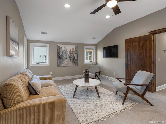 carpeted living room with vaulted ceiling and ceiling fan