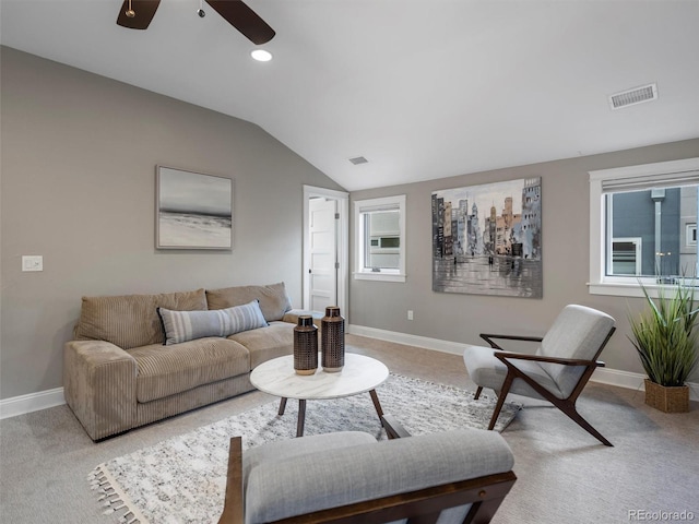 living room featuring ceiling fan, carpet flooring, and lofted ceiling