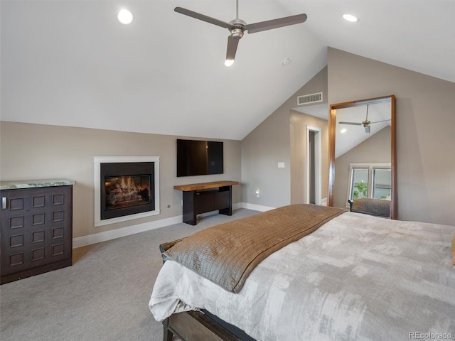 bedroom with light carpet, vaulted ceiling, and ceiling fan