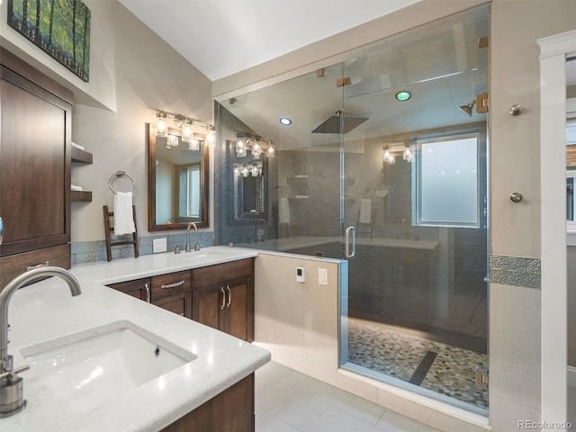 bathroom with tile patterned floors, an enclosed shower, vanity, and vaulted ceiling