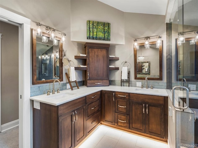 bathroom featuring tile patterned floors, lofted ceiling, and vanity