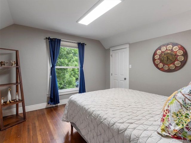 bedroom featuring lofted ceiling and dark hardwood / wood-style flooring