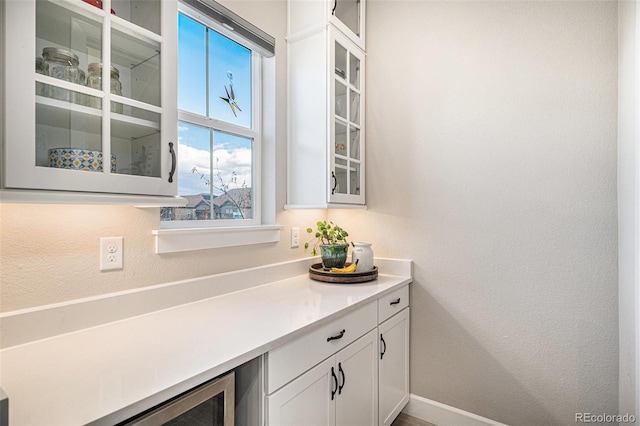 bar featuring white cabinets and wine cooler