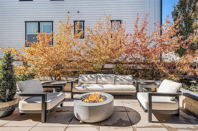 view of patio / terrace with an outdoor living space with a fire pit