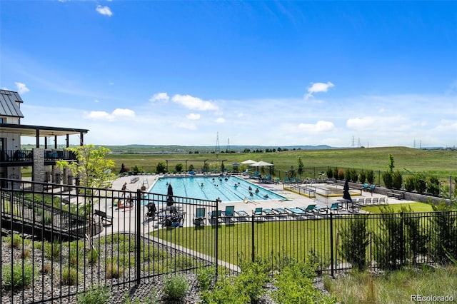 view of swimming pool with a patio and a lawn