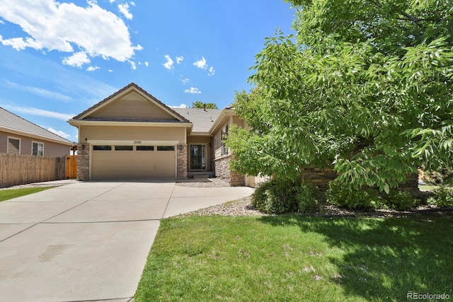 13787 Josephine Ct, Thornton, CO 80602 - view of front facade with concrete driveway, an attached garage, and stone siding