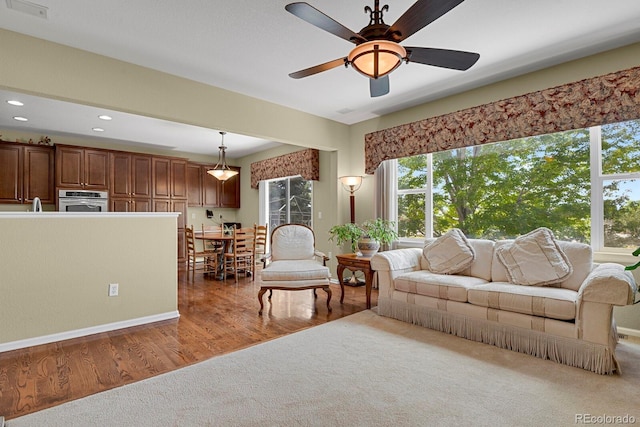 13787 Josephine Ct, Thornton, CO 80602 - carpeted living room featuring a ceiling fan, recessed lighting, and wood finished floors