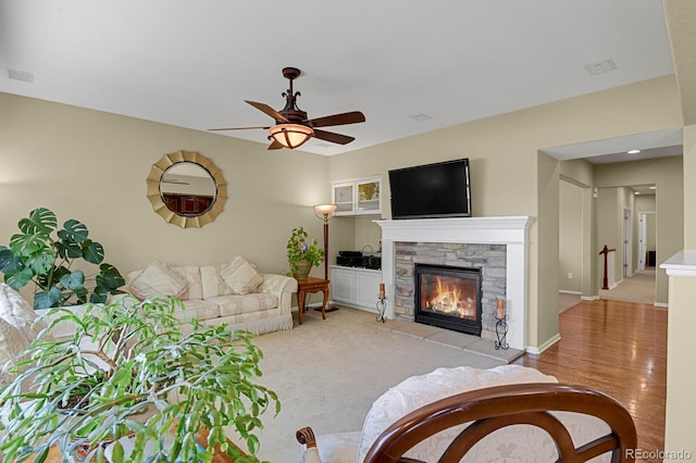 13787 Josephine Ct, Thornton, CO 80602 - living area with a stone fireplace and a ceiling fan