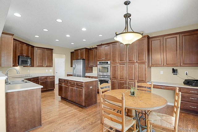 13787 Josephine Ct, Thornton, CO 80602 - kitchen with stainless steel appliances, recessed lighting, light wood-type flooring, light countertops, and hanging light fixtures