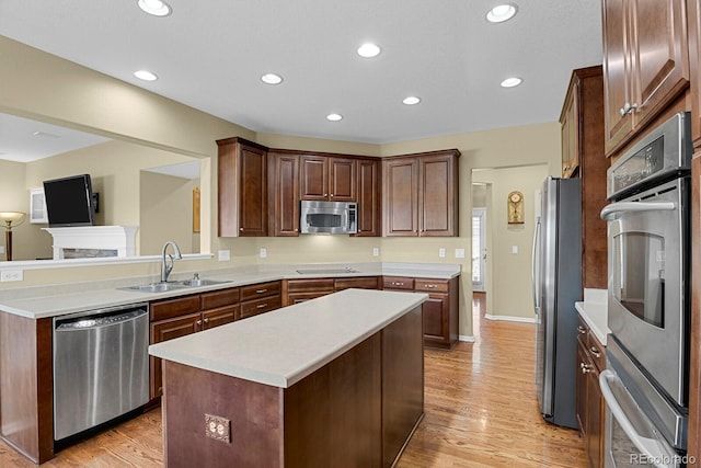 13787 Josephine Ct, Thornton, CO 80602 - kitchen with stainless steel appliances, a kitchen island, light countertops, light wood-style floors, and recessed lighting