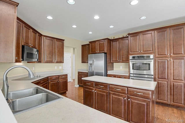 13787 Josephine Ct, Thornton, CO 80602 - kitchen with appliances with stainless steel finishes, recessed lighting, light wood finished floors, and light countertops