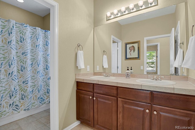 13787 Josephine Ct, Thornton, CO 80602 - bathroom featuring double vanity, tile patterned floors, and a shower with shower curtain