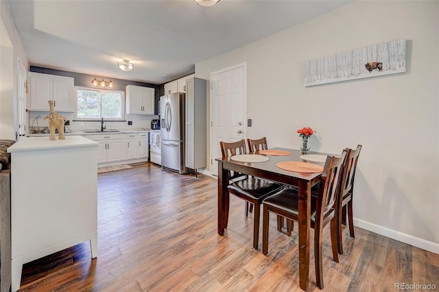 dining room featuring hardwood / wood-style flooring and sink