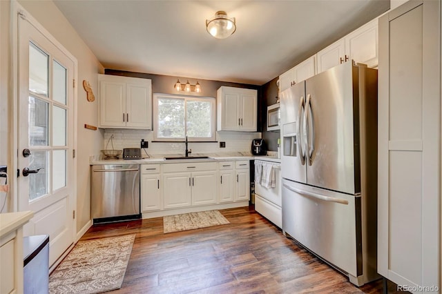 kitchen with sink, white cabinets, and appliances with stainless steel finishes