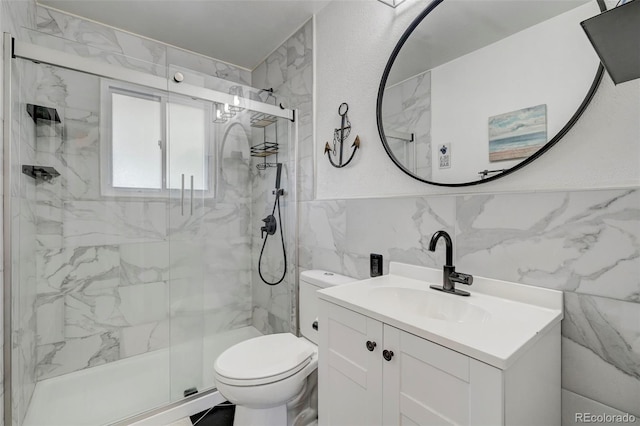 bathroom with vanity, tile walls, toilet, and walk in shower