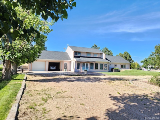 view of front of property featuring a garage and a front yard