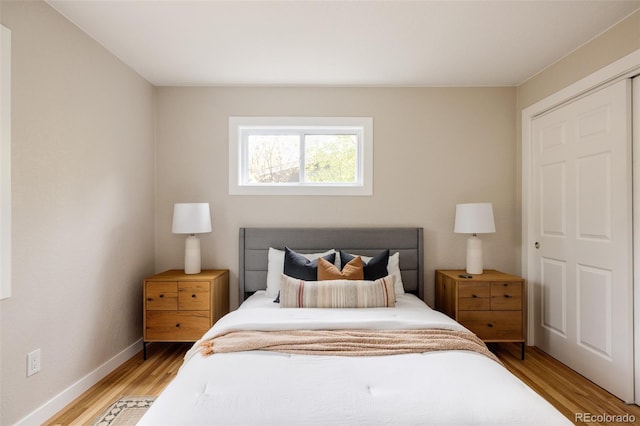 bedroom with light hardwood / wood-style flooring and a closet