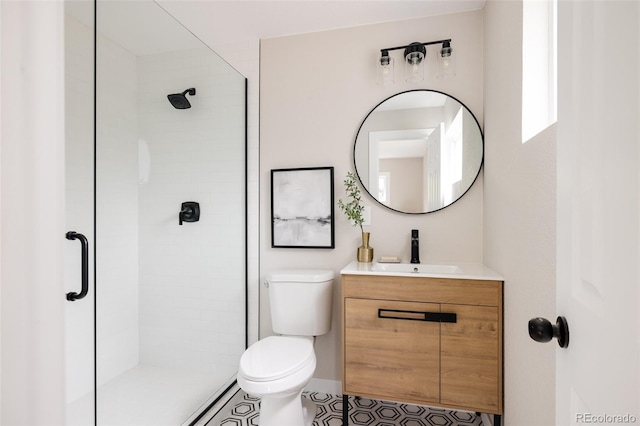 bathroom with vanity, a shower with shower door, toilet, and tile patterned flooring