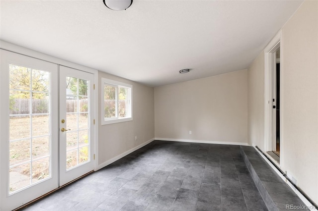 unfurnished room featuring french doors