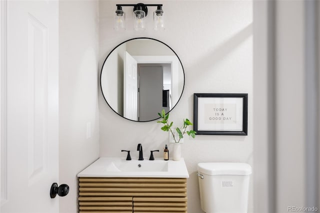 bathroom featuring vanity and toilet