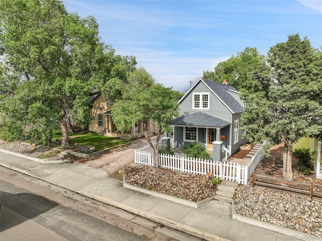 2803 N Cascade Ave, Colorado Springs, CO 80907 - view of front facade with covered porch, a fenced front yard, and roof with shingles