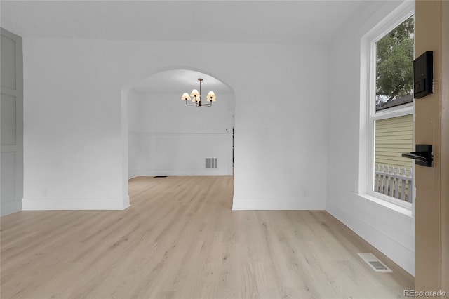 2803 N Cascade Ave, Colorado Springs, CO 80907 - unfurnished room with a chandelier, arched walkways, and wood finished floors