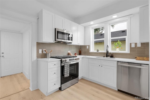 2803 N Cascade Ave, Colorado Springs, CO 80907 - kitchen with appliances with stainless steel finishes, light wood-type flooring, light countertops, white cabinets, and recessed lighting