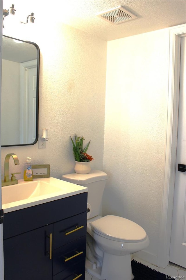12528 Ash St, Thornton, CO 80241 - half bathroom featuring vanity, toilet, and tile patterned floors