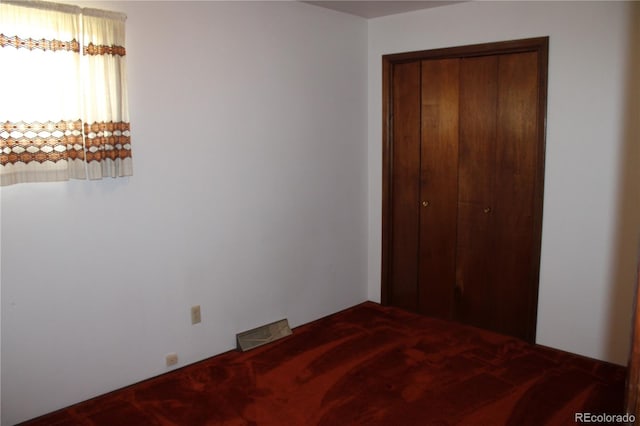 unfurnished bedroom featuring a closet and carpet