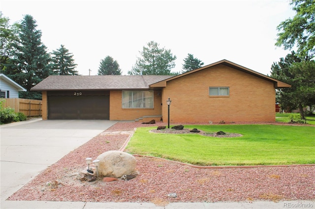 ranch-style home featuring a front lawn and a garage