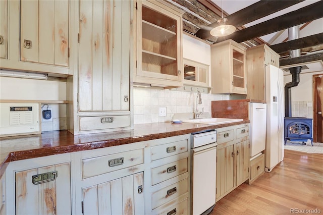 kitchen featuring cream cabinets, light wood-type flooring, backsplash, white dishwasher, and sink