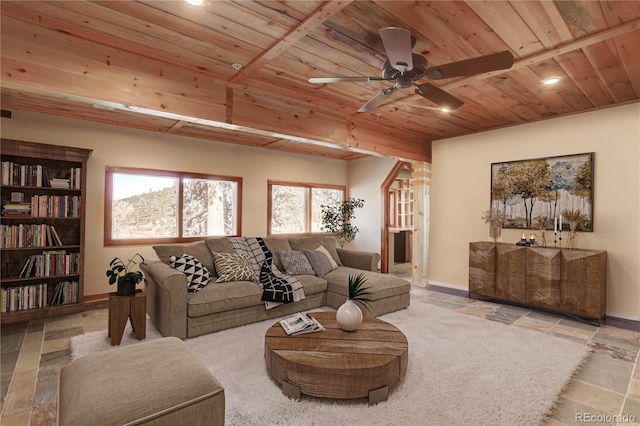 living room with tile floors, a wealth of natural light, wood ceiling, and ceiling fan