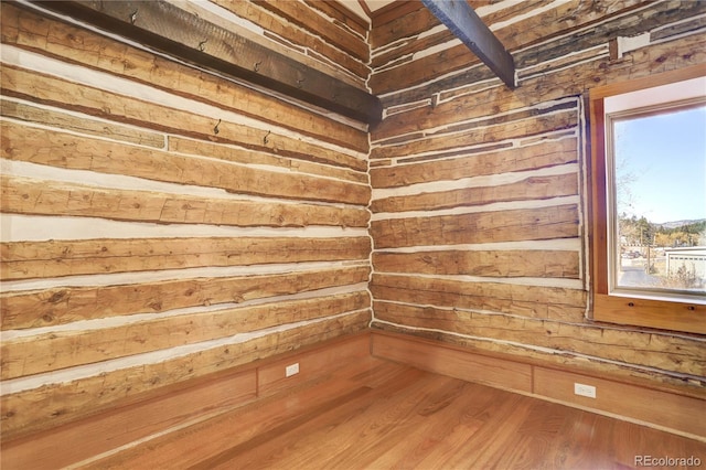 spare room with wooden walls and hardwood / wood-style flooring