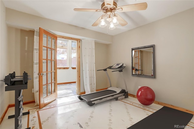 workout area featuring ceiling fan and concrete flooring