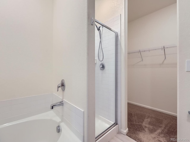 bathroom featuring separate shower and tub